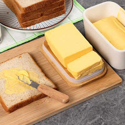 Plato de mantequilla de cerámica blanco con la tapa y el cuchillo para la encimera